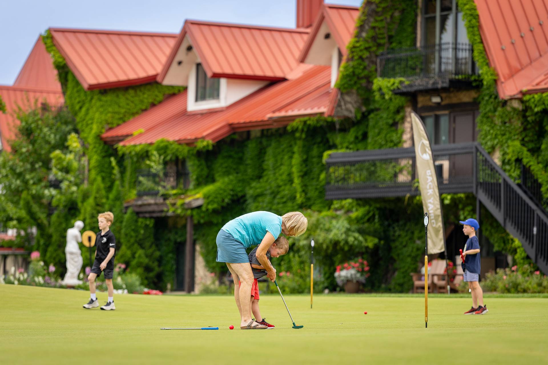 A family putting on the Back Yaird Putting Green