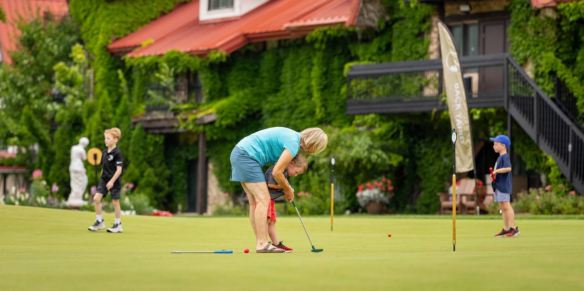 A family putting on the Back Yaird Putting Green