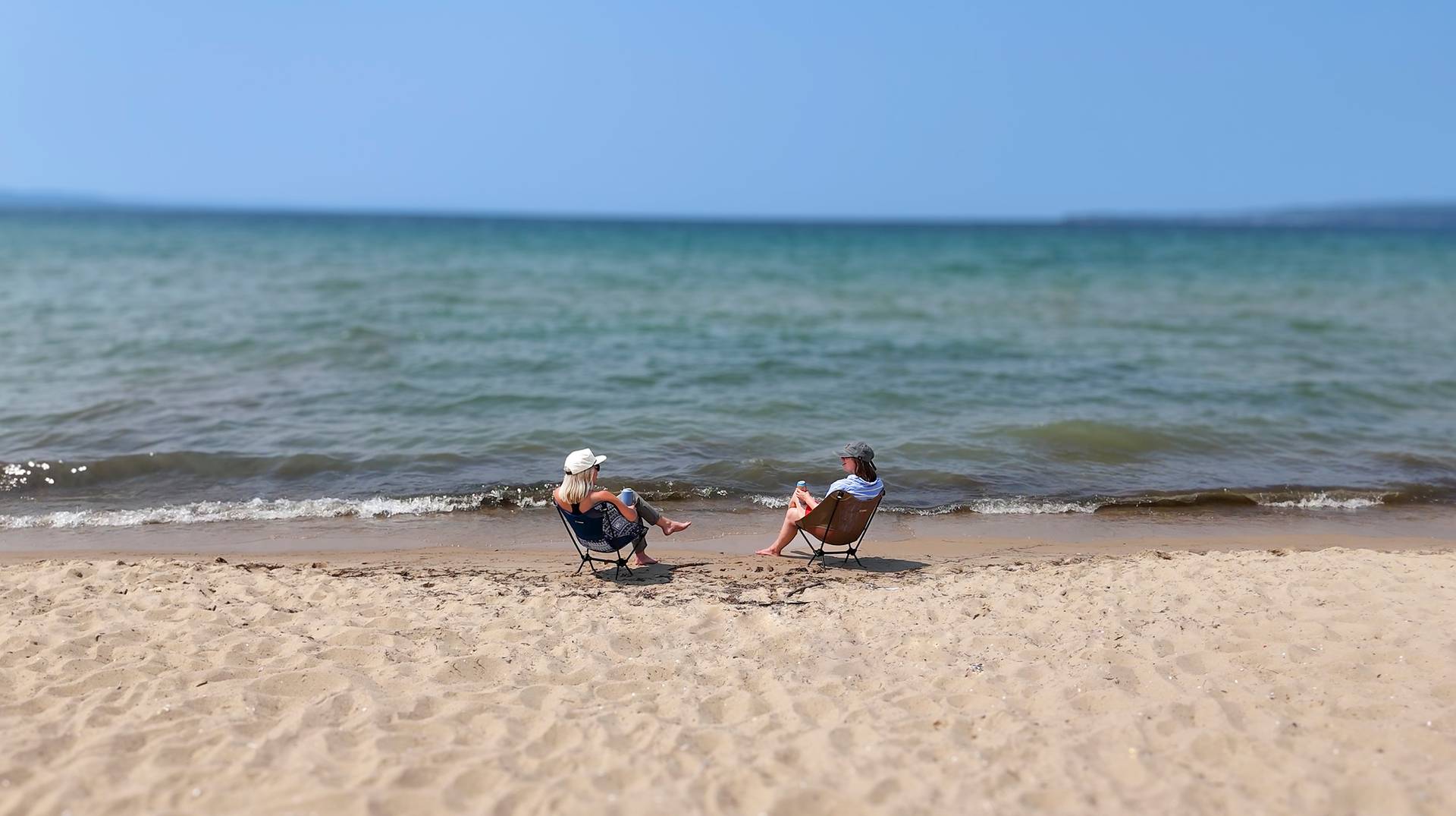 Two people sitting by Lake Michigan at Petoksey State Park