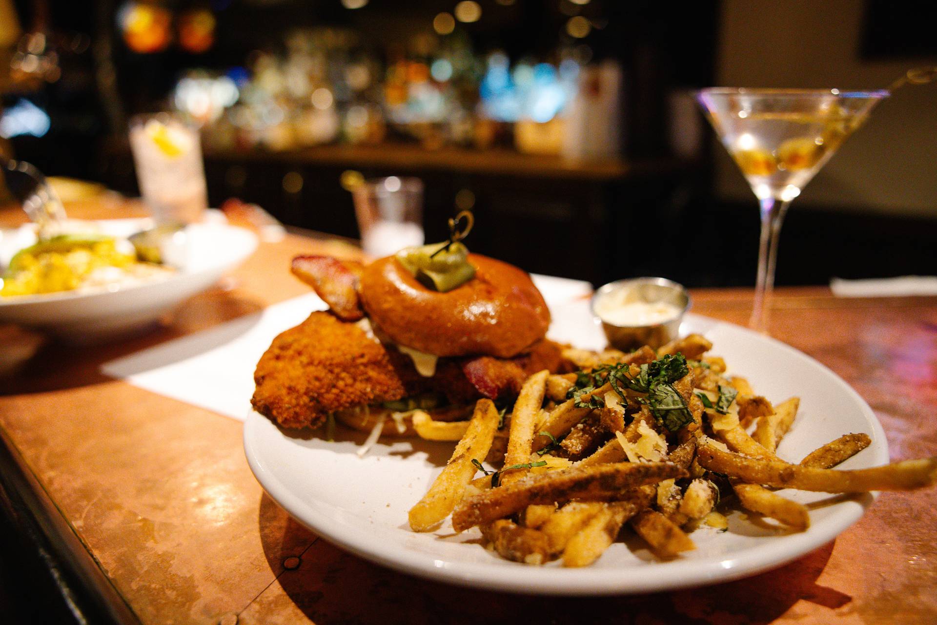 A burger and fries inside Slopeside Lounge at The Highlands