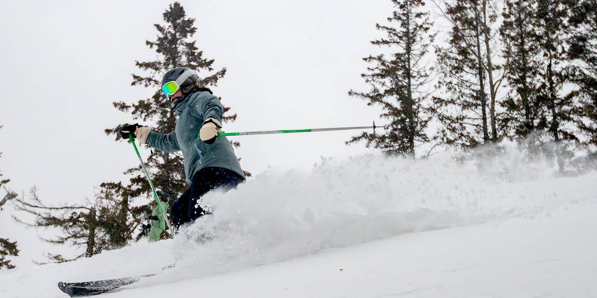 A skier in deep powder at The Highlands