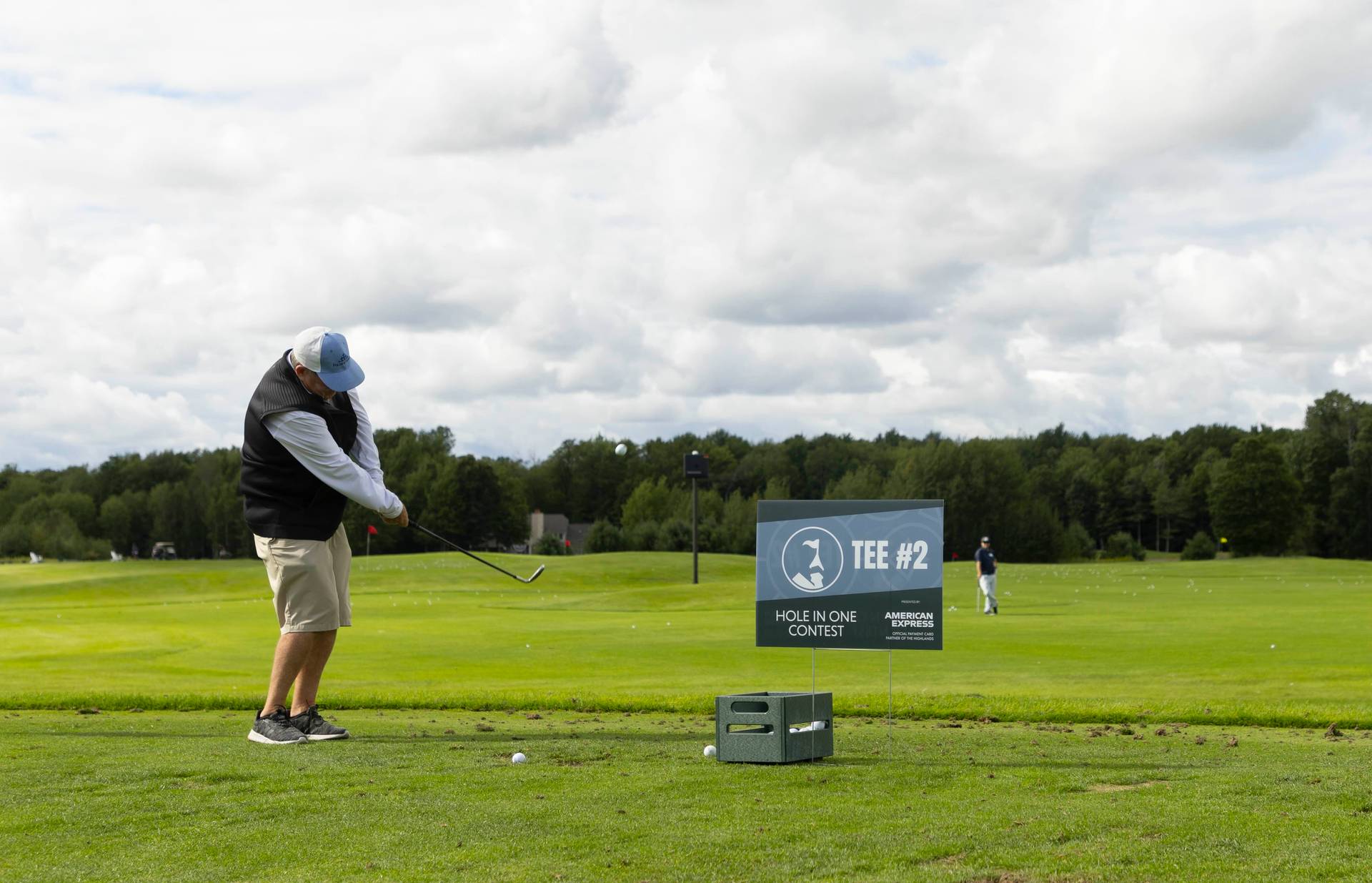 Two men golfing during a golf event at The Highlands
